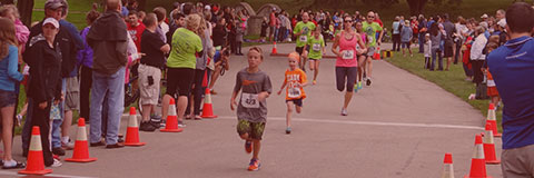 Several contestants crossing the finish line at WaunaFest Run in Waunakee, WI